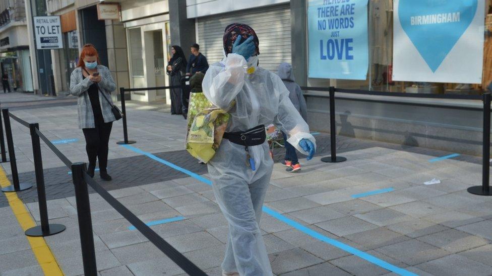 A customer dressed in PPE