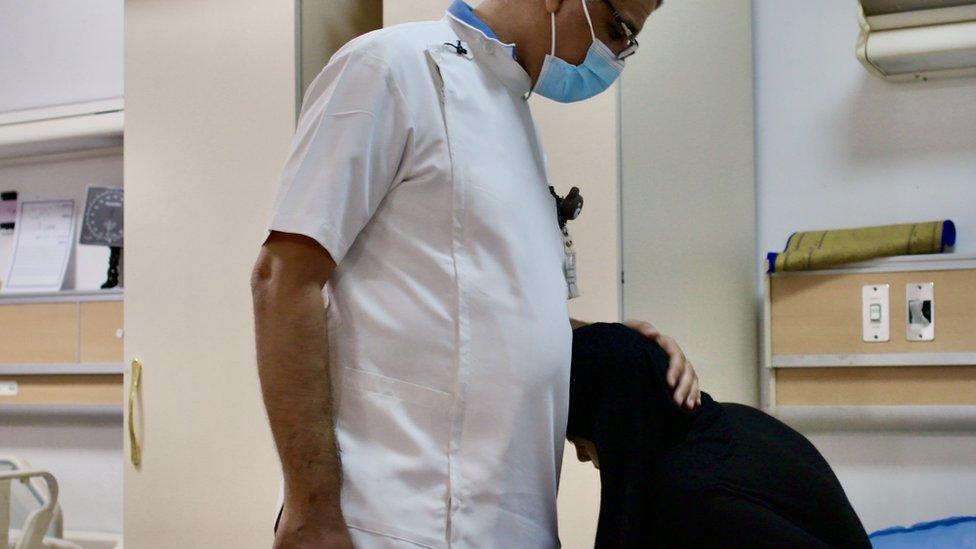 Doctor comforts Fatima whilst receiving chemotherapy treatment