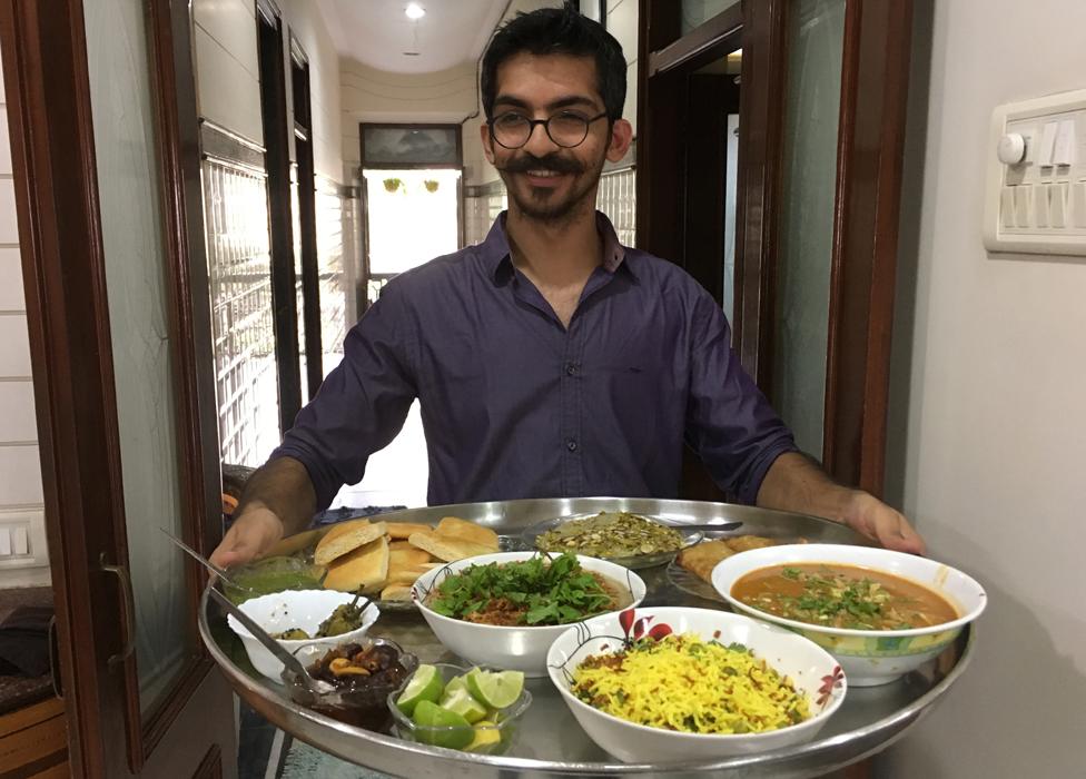 Munaf Kapadia holding a large steel platter, or "thaal"