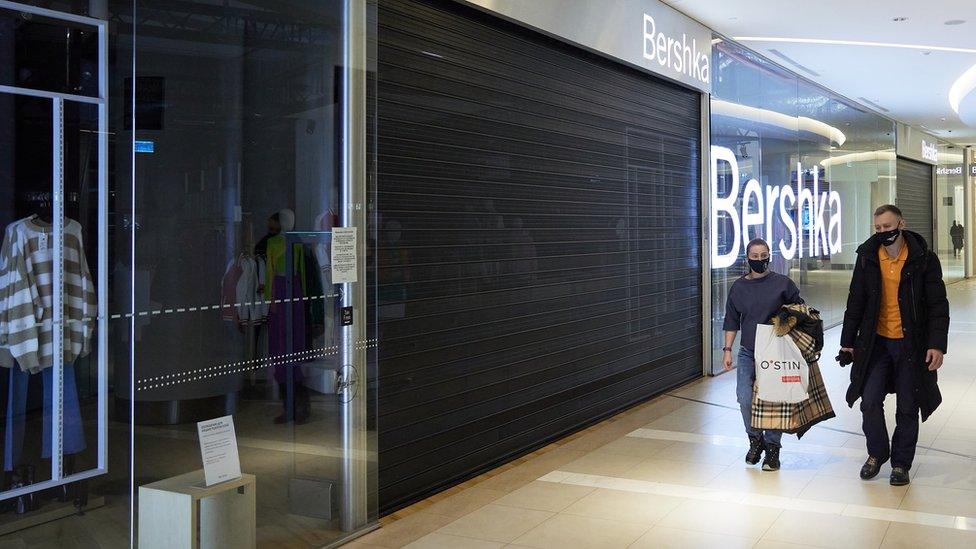 Shoppers go past a closed Bershka store in Vegas shopping mall on March 7, 2022 in Moscow, Russia