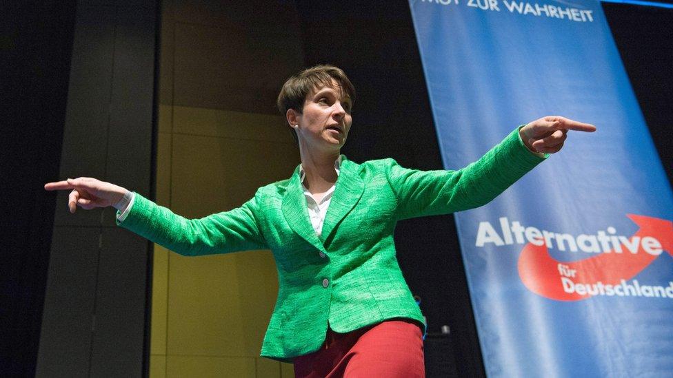 A woman onstage gesturing while she speaks