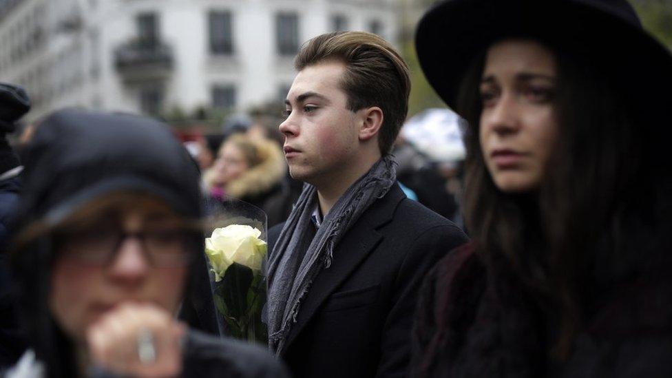 People gather outside the security perimeter set around the Bataclan concert hall in Paris, France, 13 November