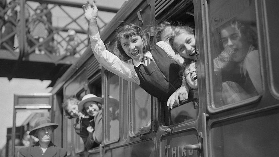 19th May 1940: A party of schoolchildren wave goodbye from a train window, on a day when ten thousand children were evacuated from London to Monmouth and Glamorgan