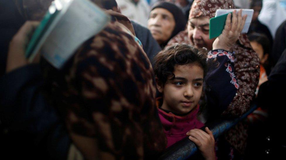 Palestinian refugees wait to receive aid at a United Nations food distribution centre in Al-Shati refugee camp in Gaza City January 15, 2018