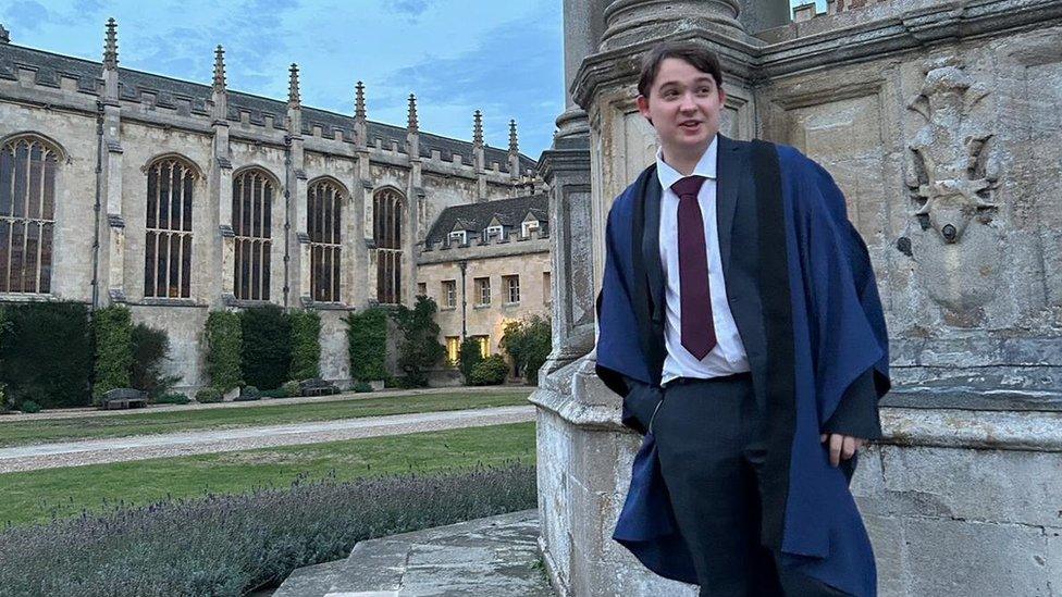 George in his robes outside the university