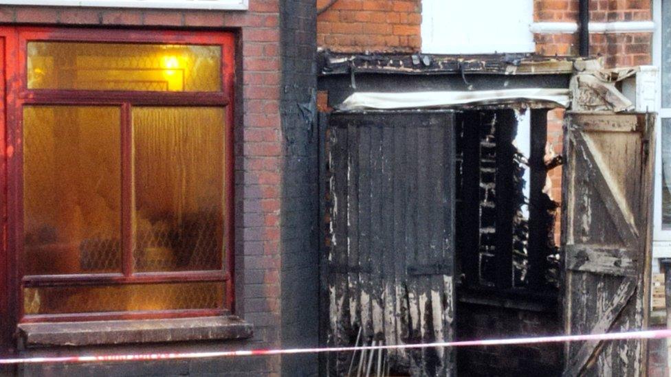 Burnt-out bin shed on ground floor of the building