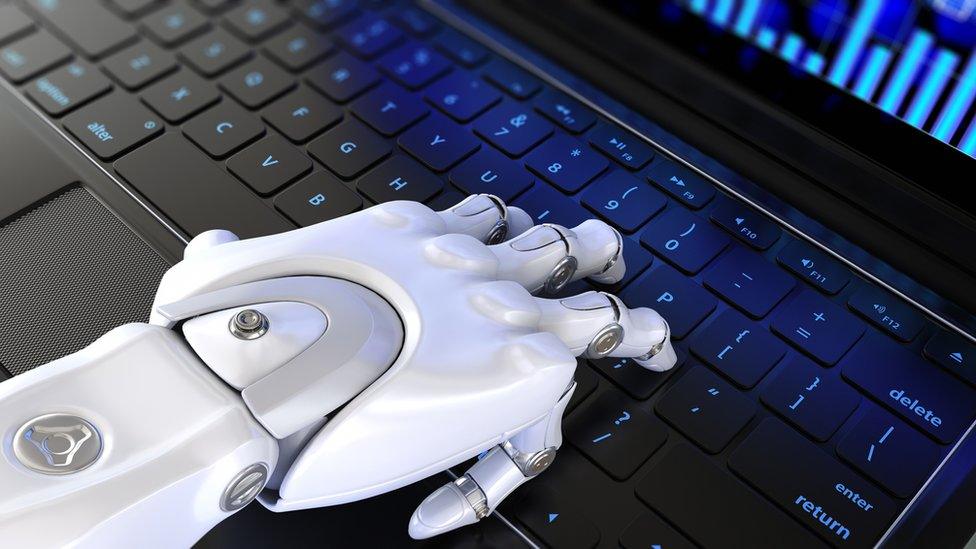 Robot hand on keyboard