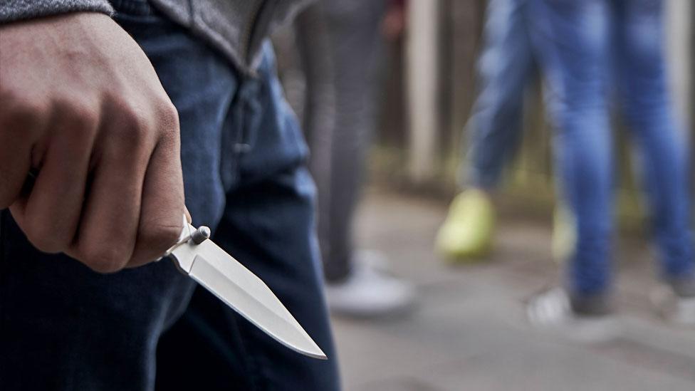 Stock image of a youth with a knife