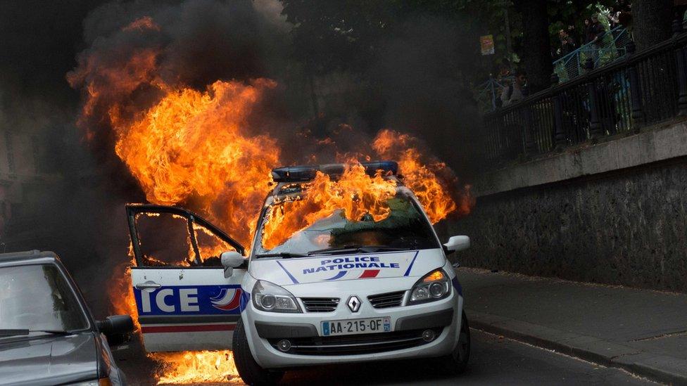 A police car burns after being set on fire during an unauthorized counter-demonstration against police violence on May 18, 2016 in Paris