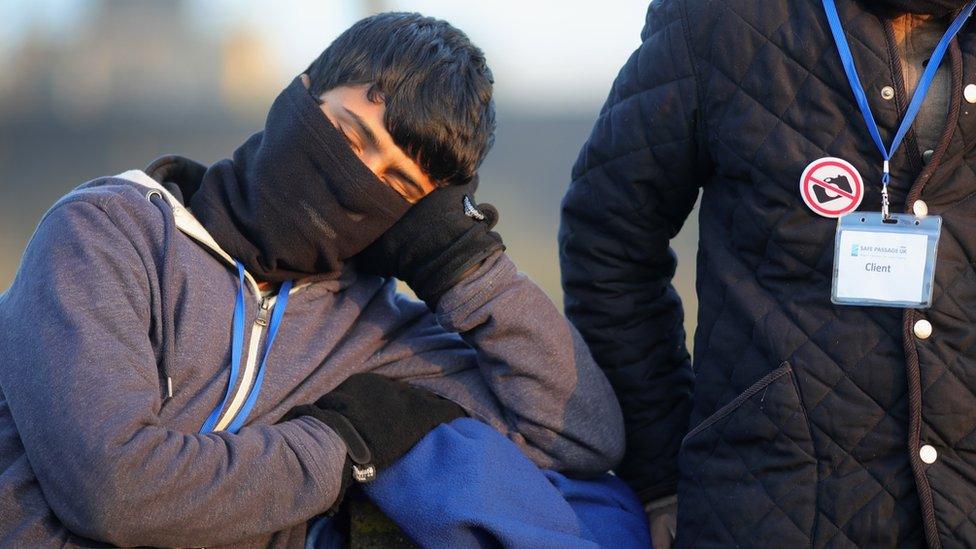 A refugee resting after registering at the reception centre in Calais 'Jungle'.