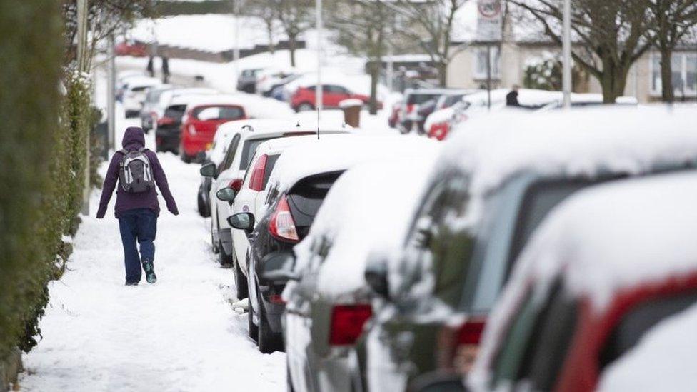 A woman walks through the snow in Penicuik, Midlothian.