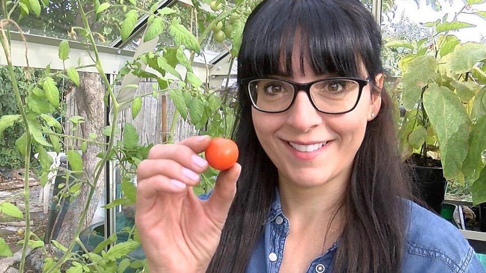 Ellen Mary holding a tomato