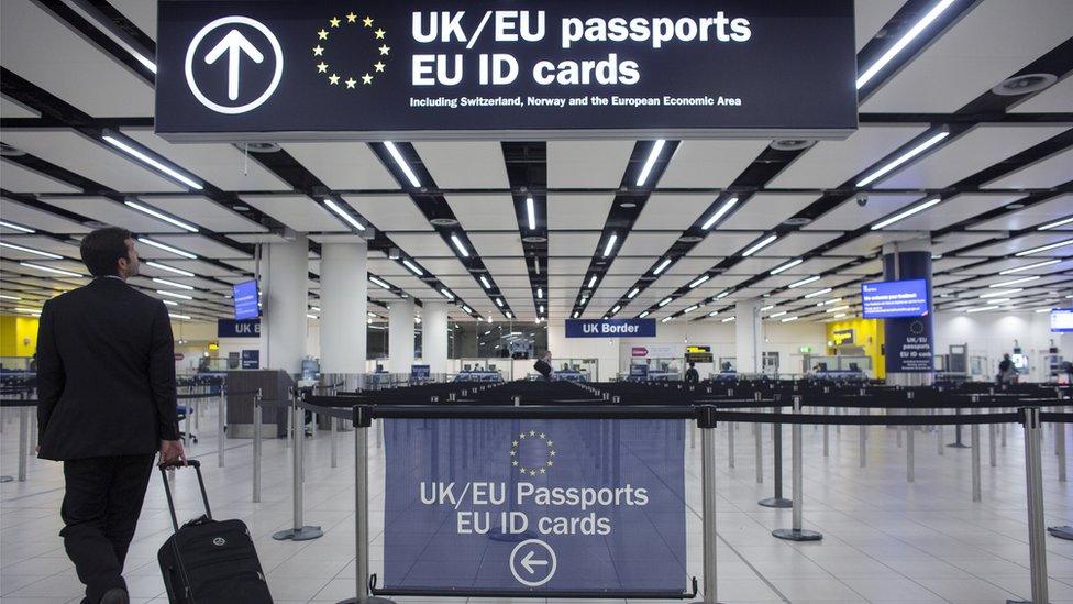 Border Force check the passports of passengers arriving at Gatwick Airport