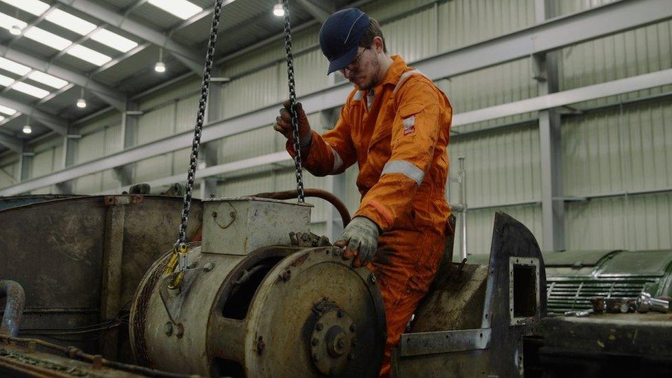 Sam Bradley, pictured here, removes part of the current engine