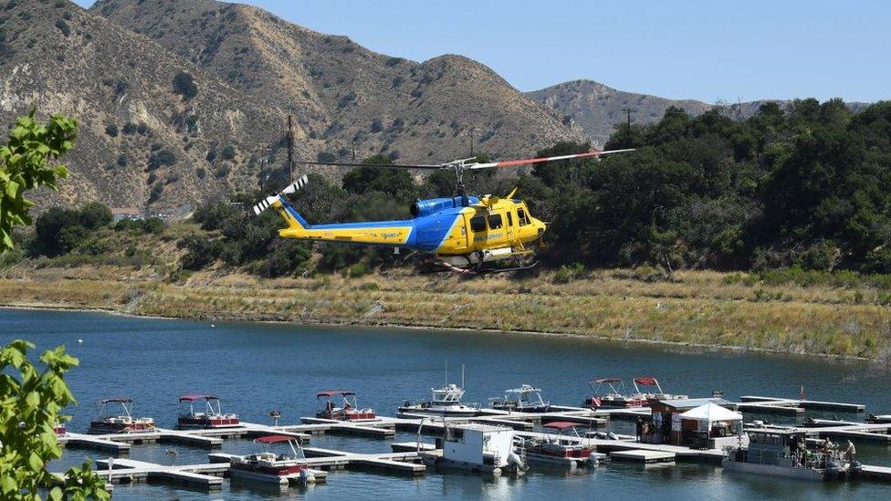 A Ventura County Sheriff's helicopter returns to base as amid the search