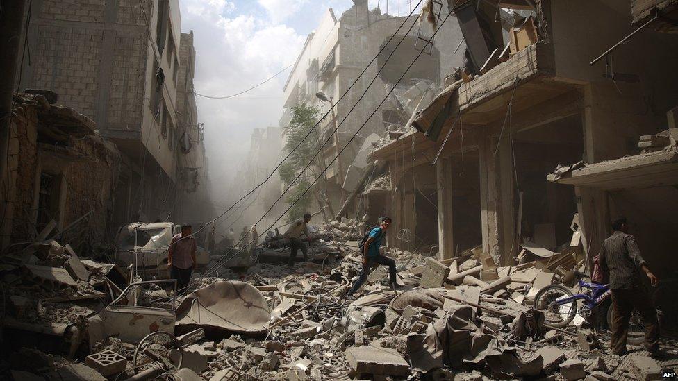 The aftermath of Syrian government airstrikes near Damascus in August