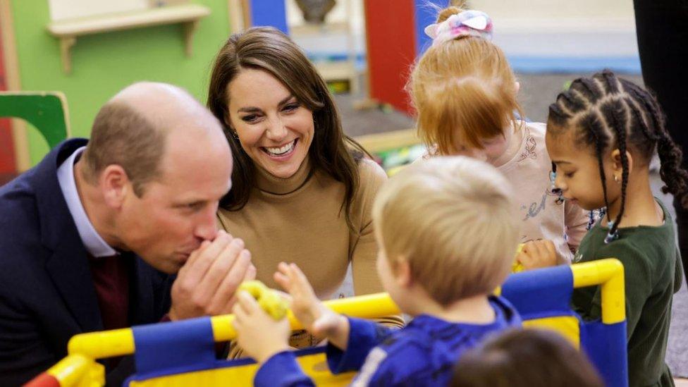 The Prince and Princess of Wales play with modelling dough as they meet children in the nursery of the Rainbow Centre