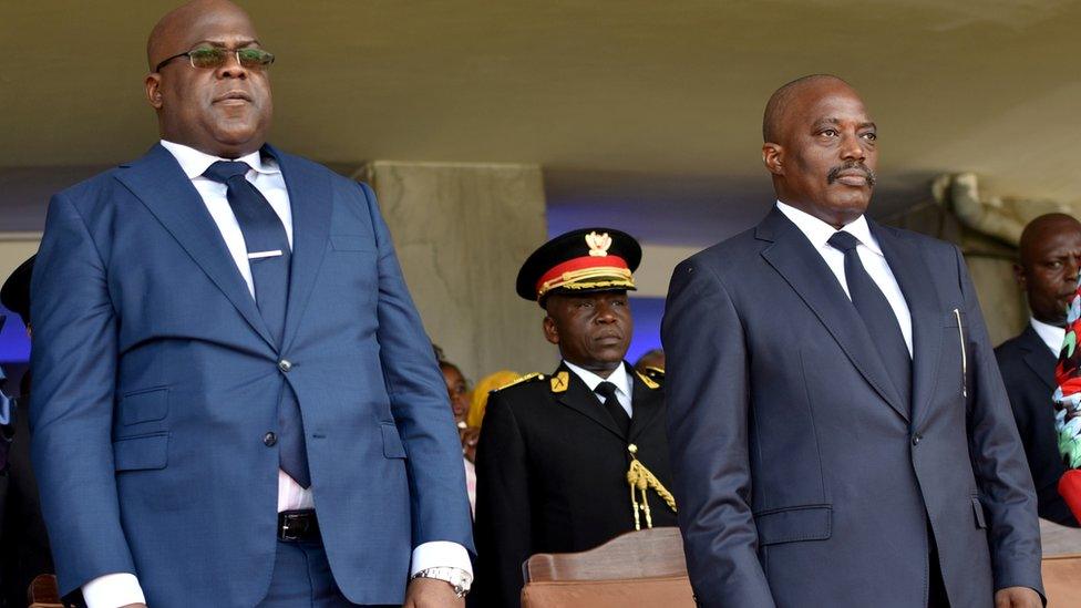 FILE PHOTO: Democratic Republic of Congo"s outgoing President Joseph Kabila and his successor Felix Tshisekedi stand during an inauguration ceremony in Kinshasa, Democratic Republic of Congo, January 24, 2019