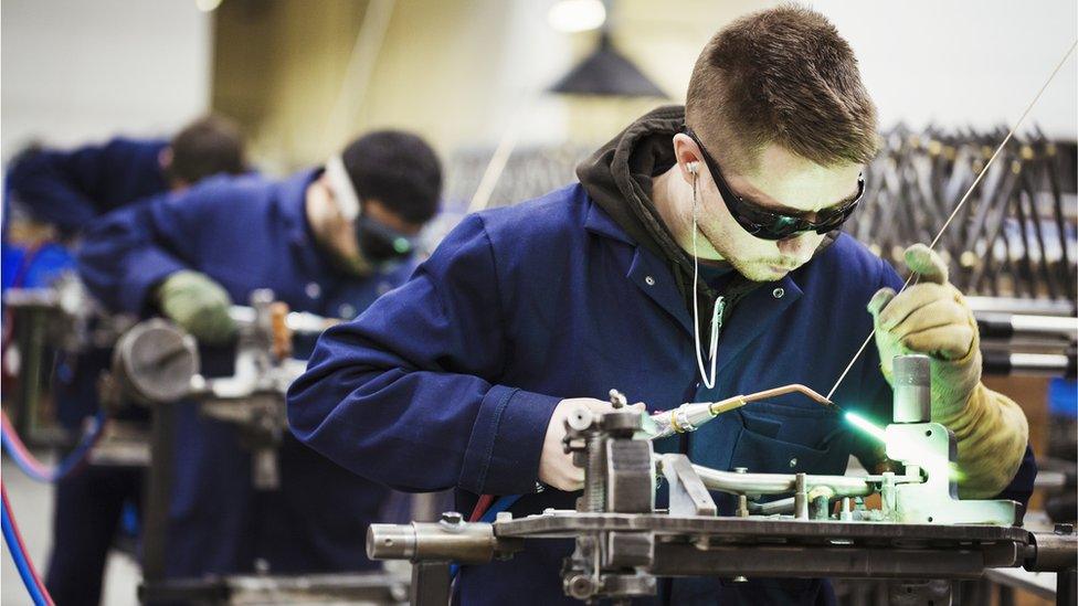 A worker welding - stock photo