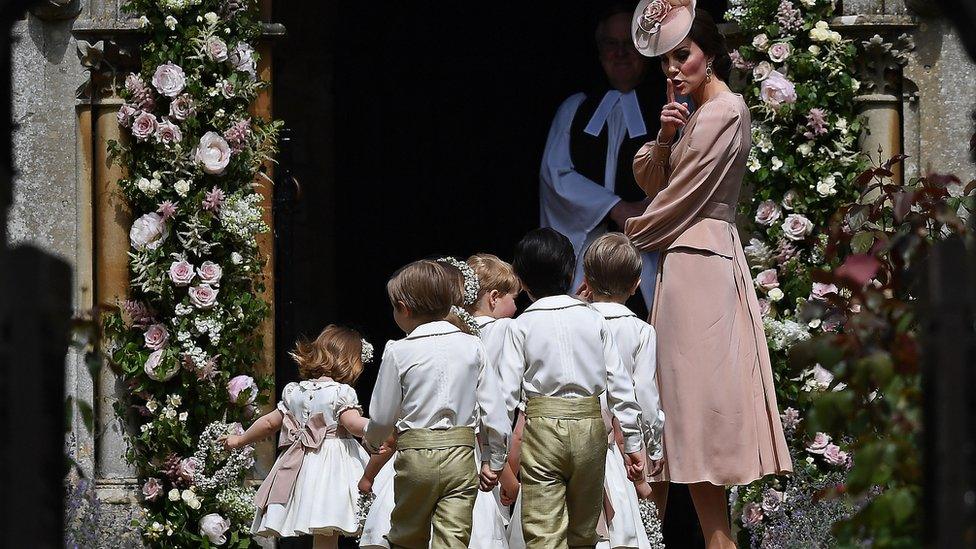 The Duchess of Cambridge stands with the page boys and bridesmaids outside church