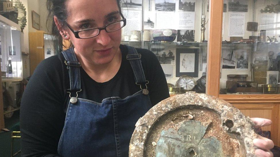 Emily Turton holds lid from cordite tub