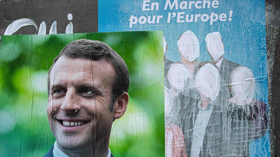 A picture shows a campaign poster for the list of the French La Republique En Marche"s (LREM) party sprayed with white paint and a portrait of French President Emmanuel Macron, on May 23, 2019