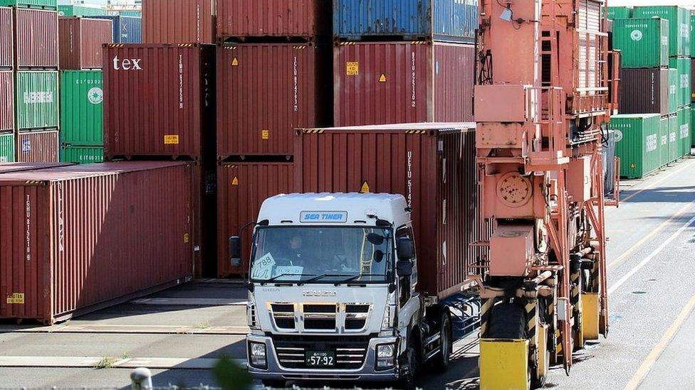 A truck leaves Tokyo's international cargo terminal