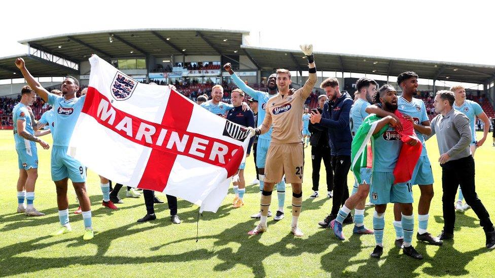 Grimsby players celebrate after securing a place in the final