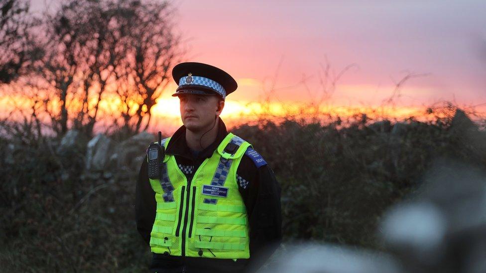 A policeman standing near to where the clothes were found