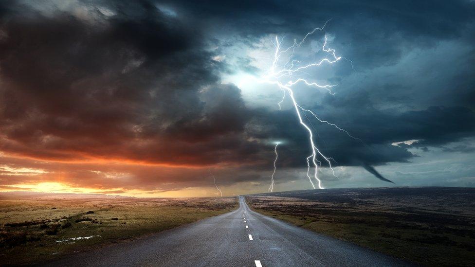 lightning on a field by a road