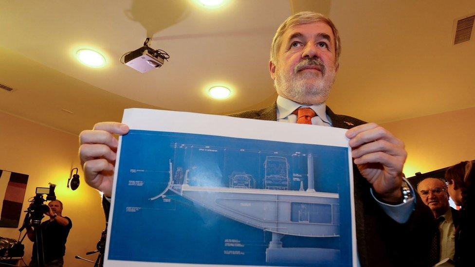 Mayor of Genoa Marco Bucci displays a section plan of the new bridge.