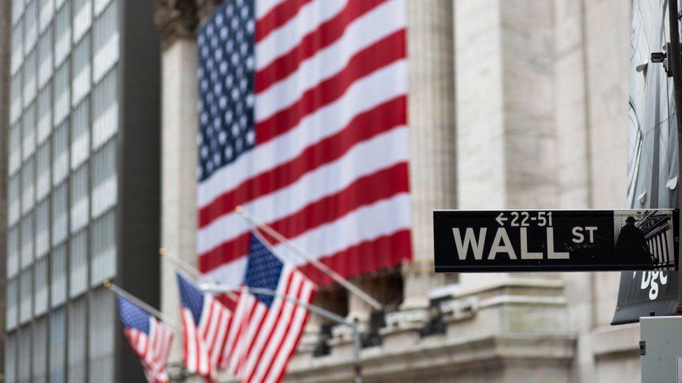 US flags outside the New York Stock Exchange on Wall Street