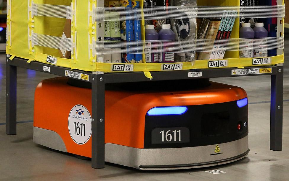 A Kiva robot moves a rack of merchandise at an Amazon fulfillment center on January 20, 2015 in Tracy, California.