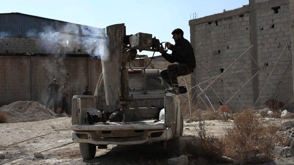 A rebel fighter fires a machine gun in Tal al-Aswan, in the eastern Ghouta region outside Damascus (9 February 2016)