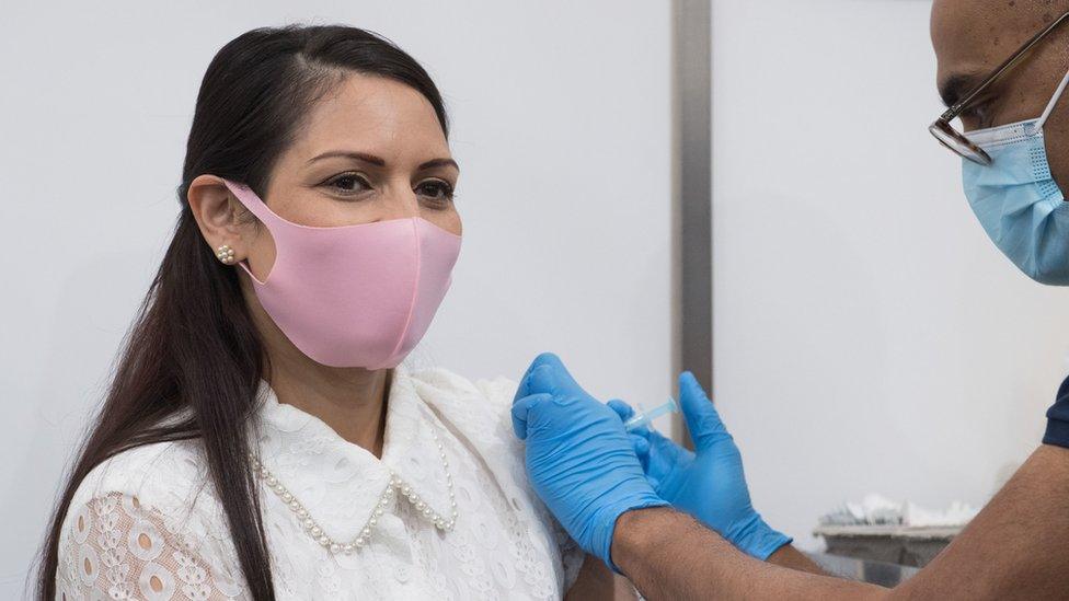 Home Secretary Priti Patel receives her first dose of the Moderna Covid-19 vaccine from Dr. Vin Diwakar at Guys Hospital in London.