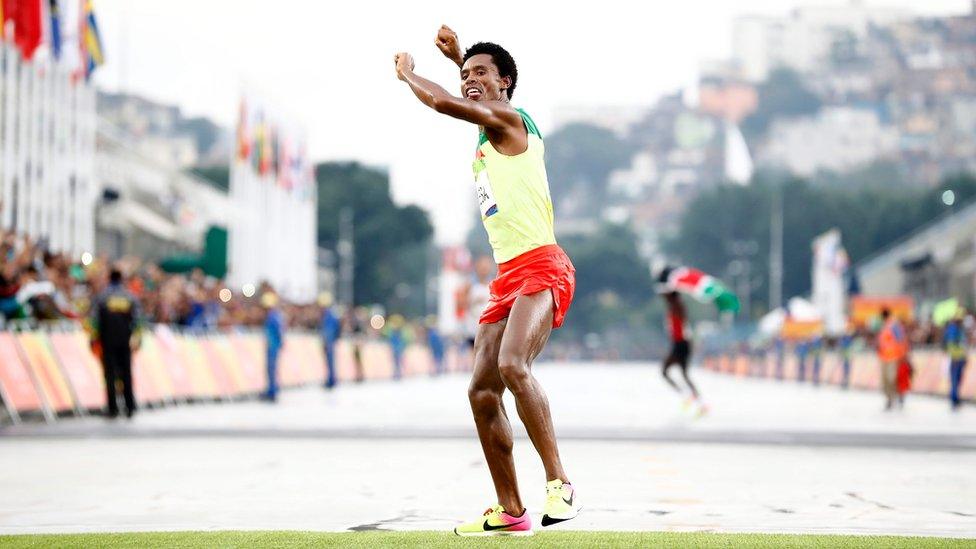 Feyisa Lilesa of Ethiopia celebrates while crossing the finish line to take the second place in the men"s Marathon race of the Rio 2016 Olympic Games Athletics, Track and Field events at the Sambodromo in Rio de Janeiro, Brazil, 21 August 2016.