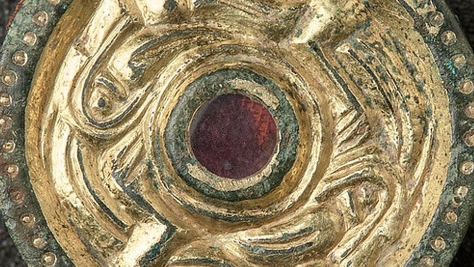 Gilded disc brooch with garnet setting, found at Rendlesham