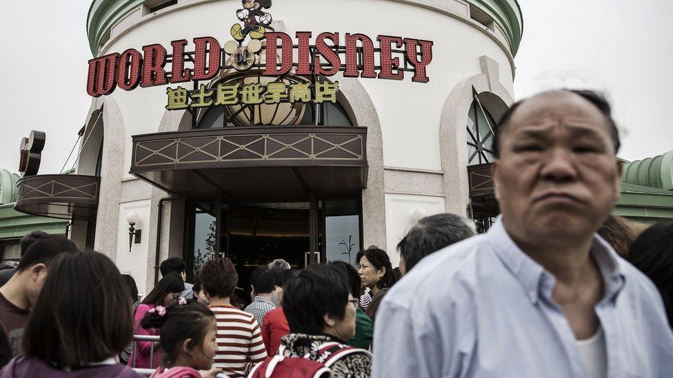 Customers wait in line at the Disneytown retail area of Walt Disney Co.'s Disneyland Resort in Shanghai, China