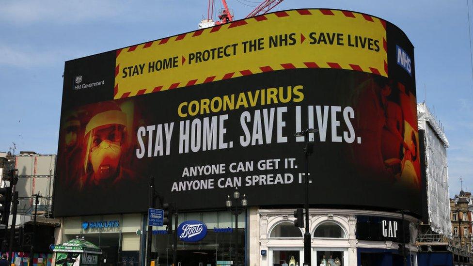 A huge sign displays health advice at Piccadilly Circus in London in April 2020