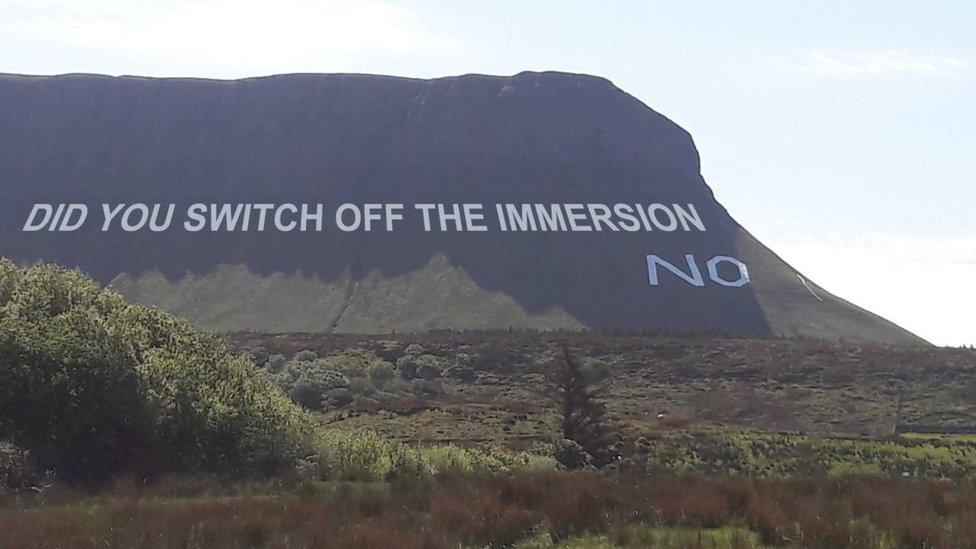 "Did you switch off the immersion? No" slogan superimposed on mountain