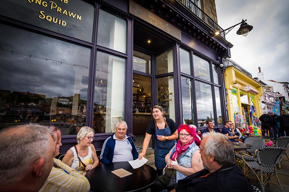 Lex Atkinson serves customers at The Moon and Sixpence, Whitby. 4 July 2020