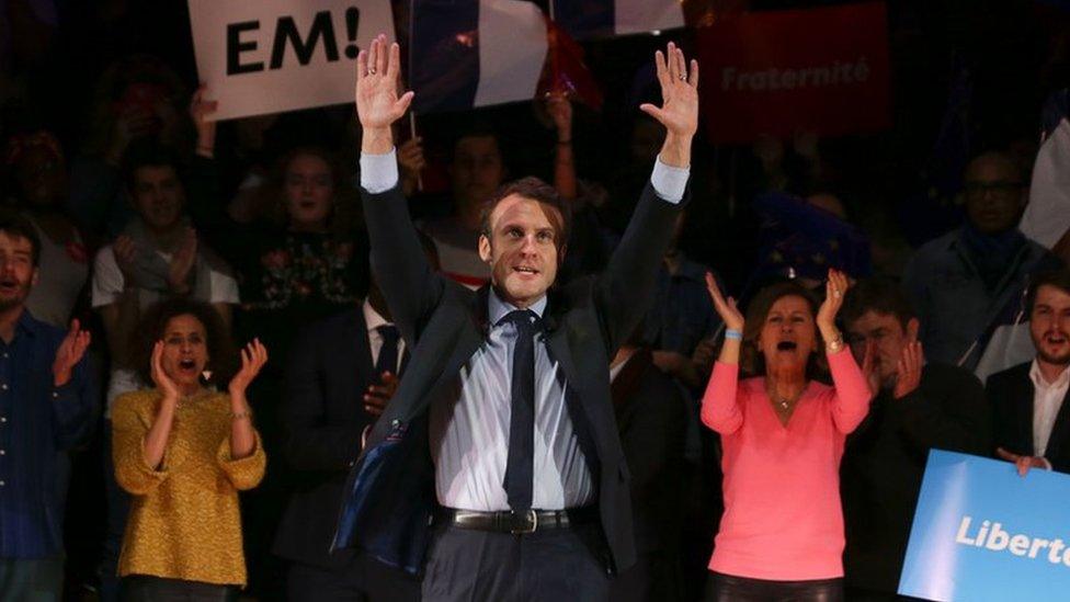 French presidential election candidate Emmanuel Macron waves on stage at the end of a campaign event in central London on February 21