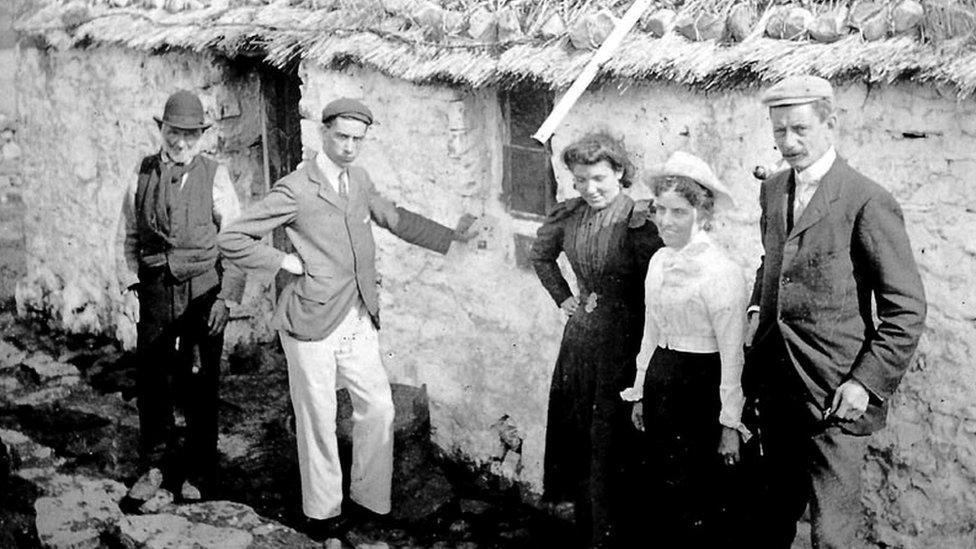 Family outside Slyne Head Post Office where turnip was dug up and posted