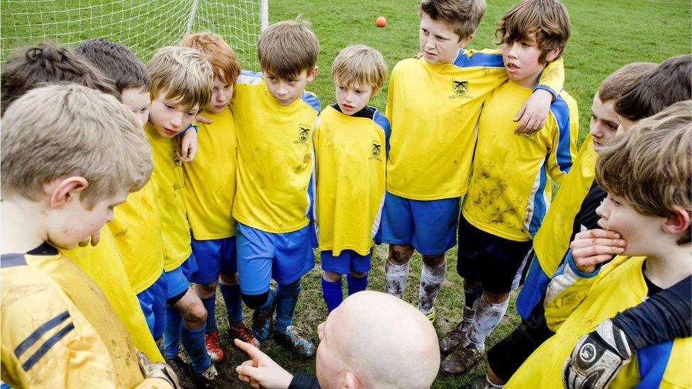 Children being coached during a football match