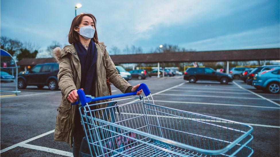 Woman at supermarket with mask