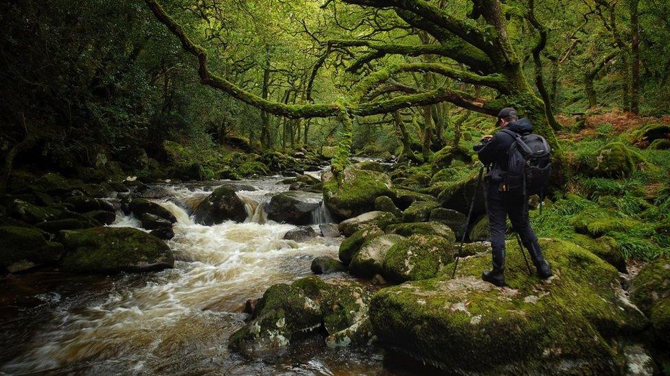 Dave taking photos by a river