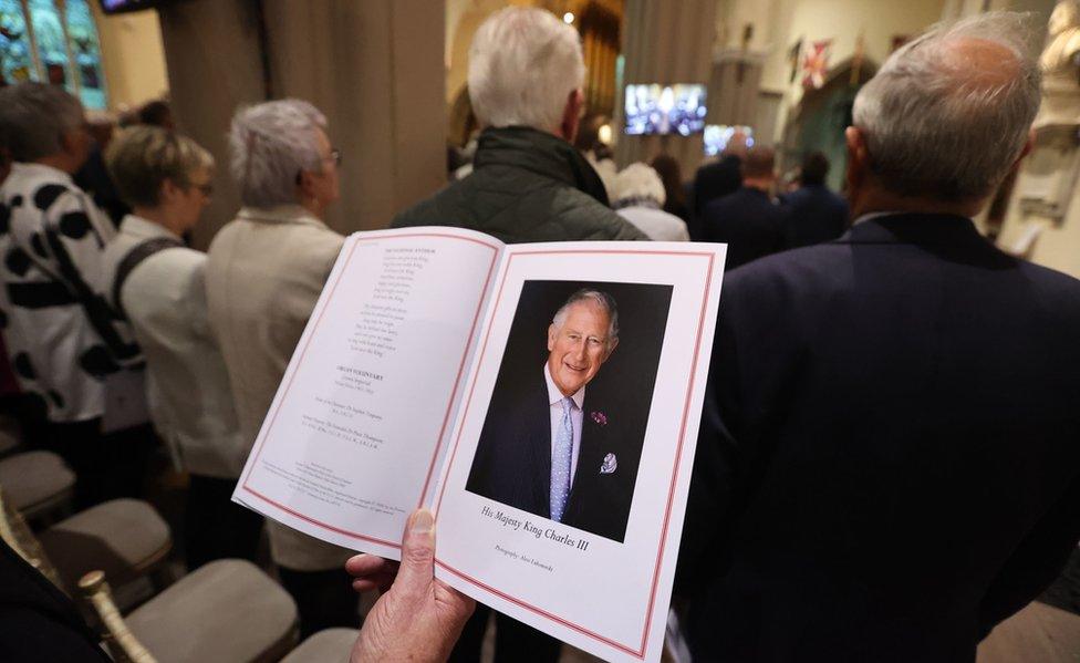 A man holds an order of service for the thanksgiving event at St Patrick's Cathedral in Armagh