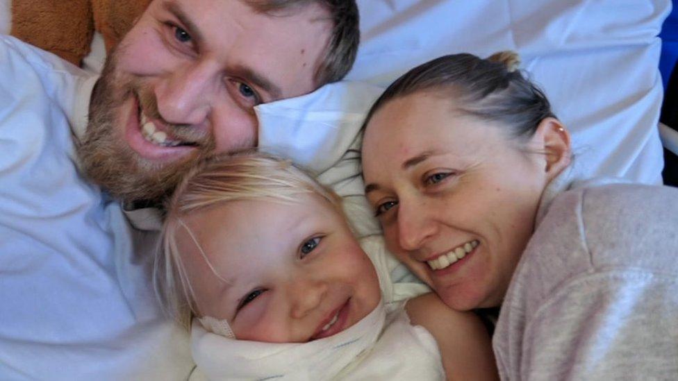 Rosie-May with her mum and dad after she was injured by a firework