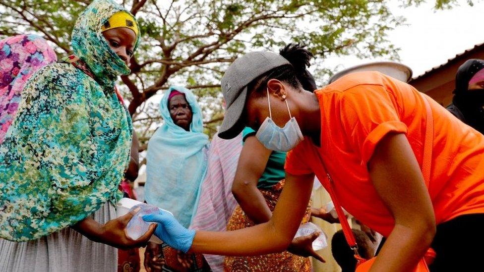 A volunteer distributes cooked food and water to the underprivileged and homeless, as Ghana enforces a partial lockdown in Accra and Kumasi in efforts to slow the spread of the coronavirus disease (COVID-19), in Accra, Ghana. April 4, 2020