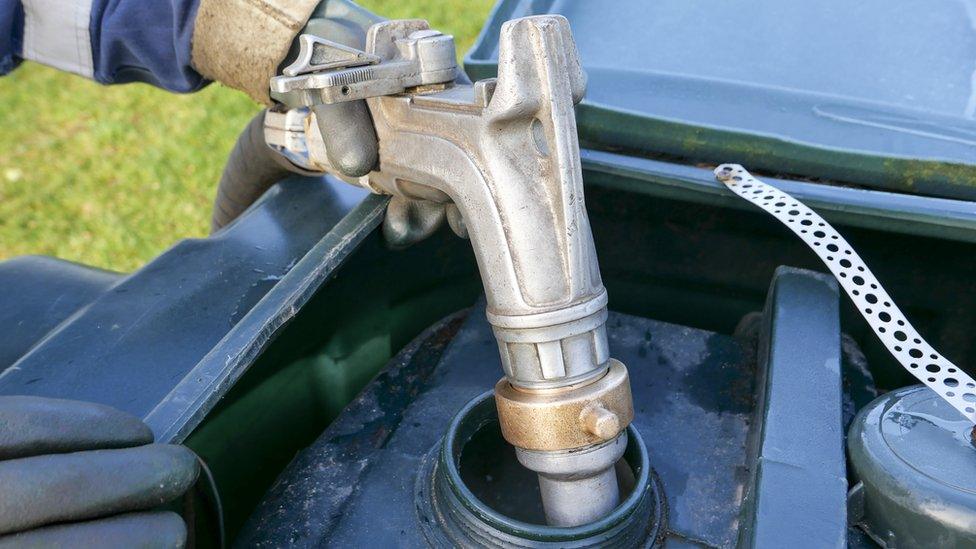 Oil being dispensed into a home heating tank